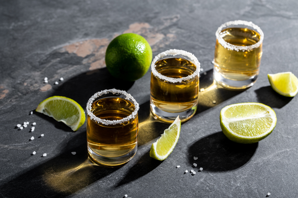 Tequila Shot with Limes. Photography by sweet marshmallow. Image via Shutterstock