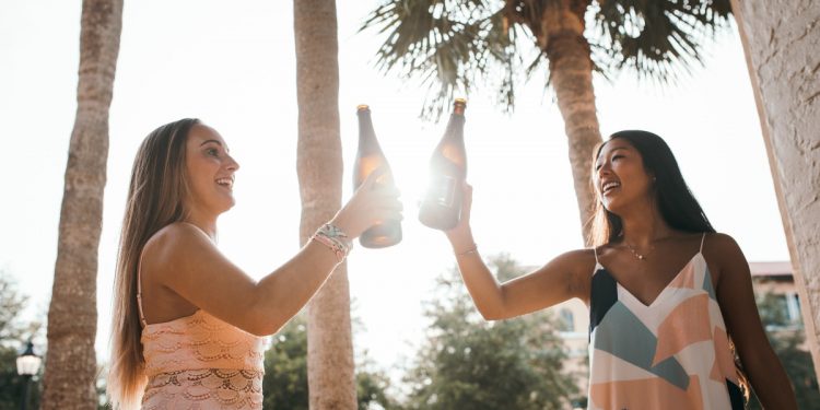 Girls drinking wine in summer. Photographed by KAL VISUALS. Image via Unsplash