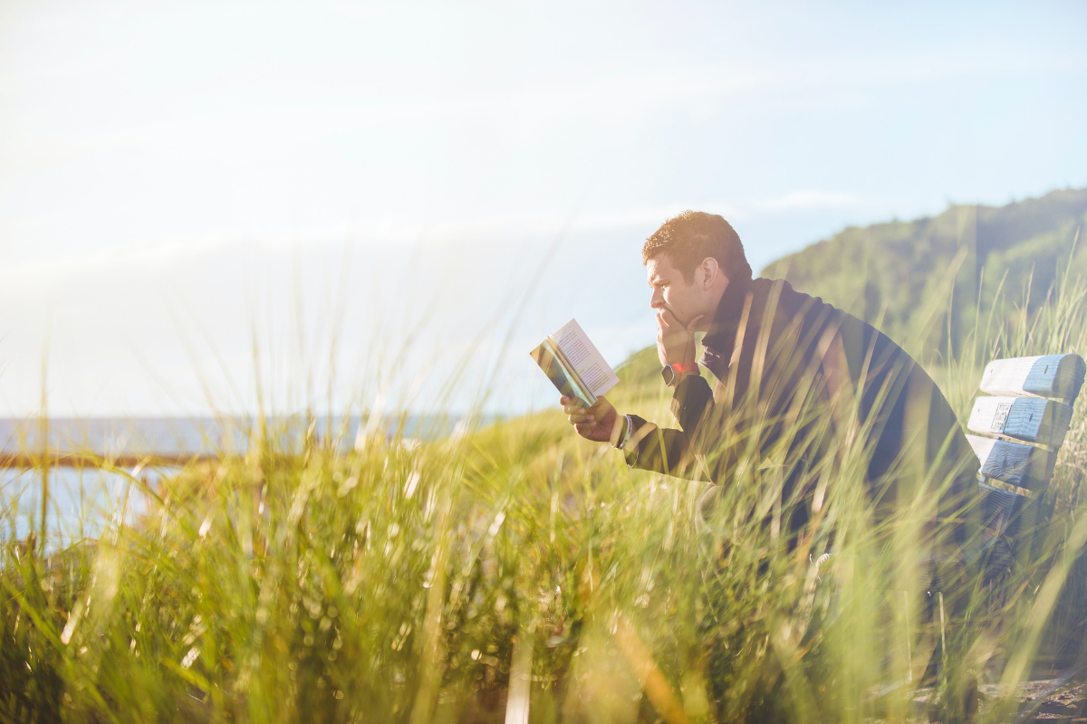 Man reading book. Photo by Ben White. Image via Unsplash