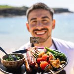 Jono Castano with his plant-based plate of barbecued Alternative Meat Co. sausages. Image: Supplied