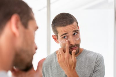 Man applying skincare routine for men