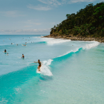 Surfers at Noosa National Park in Noosa, Queensland.