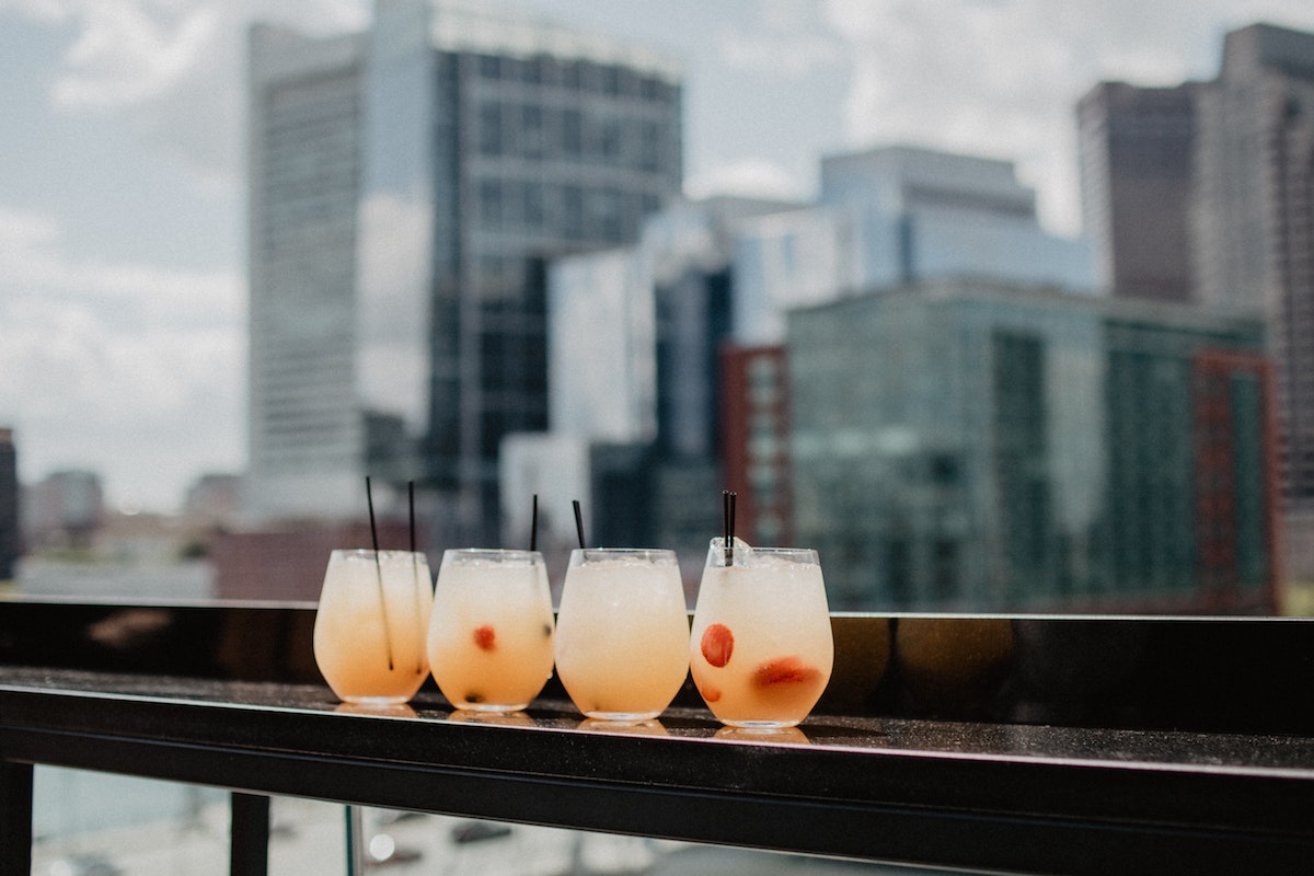 Rooftop drinks. Photographed by Kelly Sikkema. Image via Unsplash