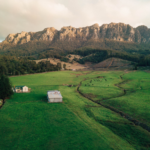 Farm in Tasmanian Mountainside. Photographed by Shaneyshoots. Image via Shutterstock.