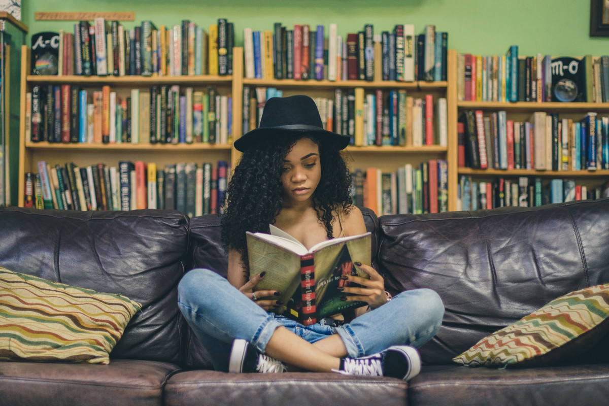 Woman reading book, short story. Photographed by Seven Shooter. Image via Unsplash