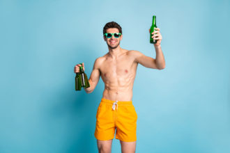 Man drinking alcohol-free beer non-alcoholic. Photographed by Roman Samborskyi. Image via Shutterstock