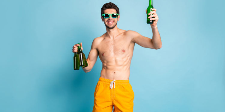 Man drinking alcohol-free beer non-alcoholic. Photographed by Roman Samborskyi. Image via Shutterstock