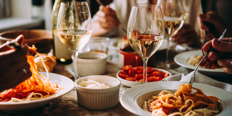 Friends Eating Italian Food. Photography by Yulia Grigoryeva. Image via Shutterstock