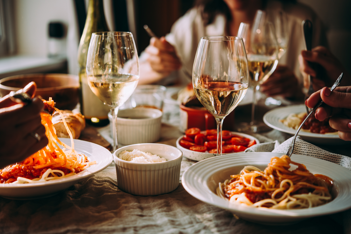 Friends Eating Italian Food. Photography by Yulia Grigoryeva. Image via Shutterstock