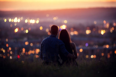 Couple staring at city. Photography by Parilov. Image via Shutterstock