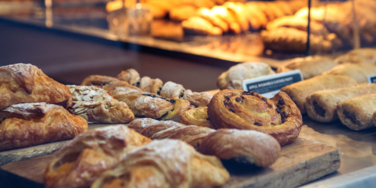 Pastries in a bakery window. Photography by ampersandphoto. Image via Shutterstock.