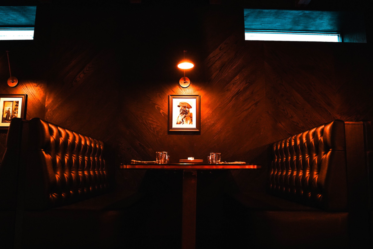 Brown wooden booth in bar. Photography by Carson Masterson. Image via Unsplash