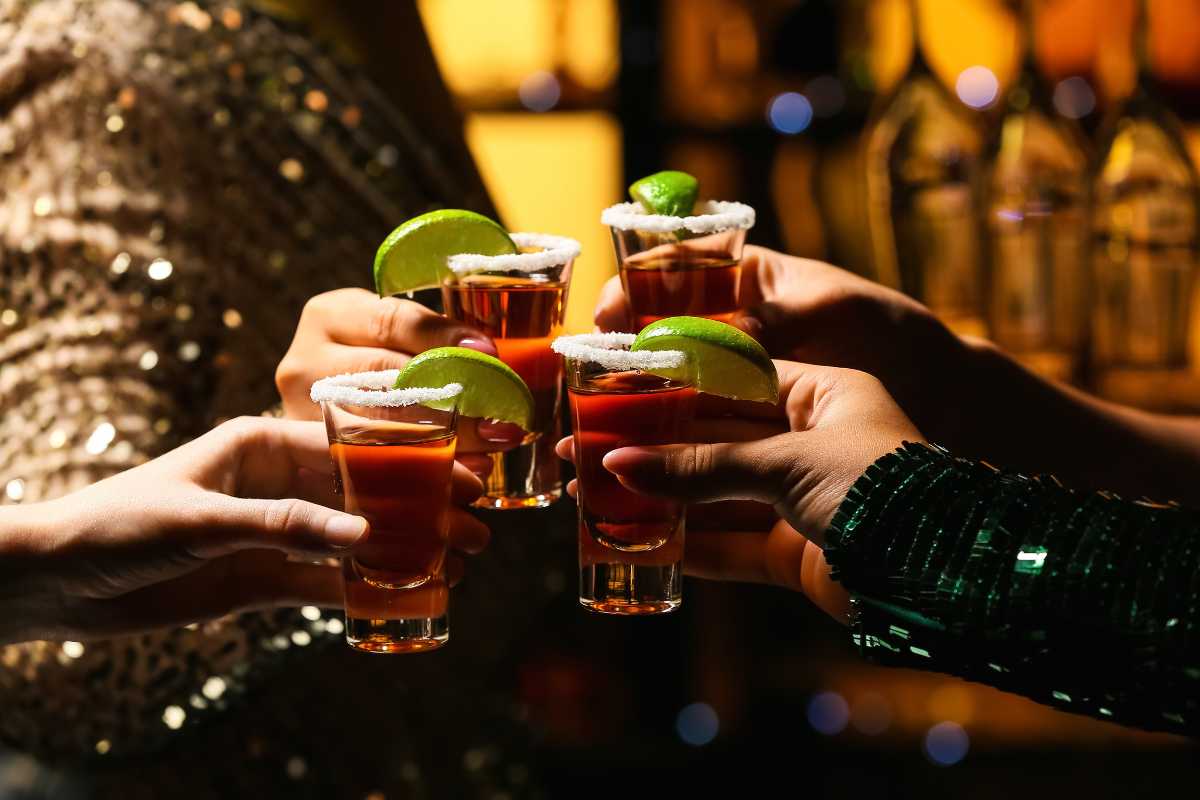 Four tequila shots. Photography by Pixel-Shot. Image via Shutterstock