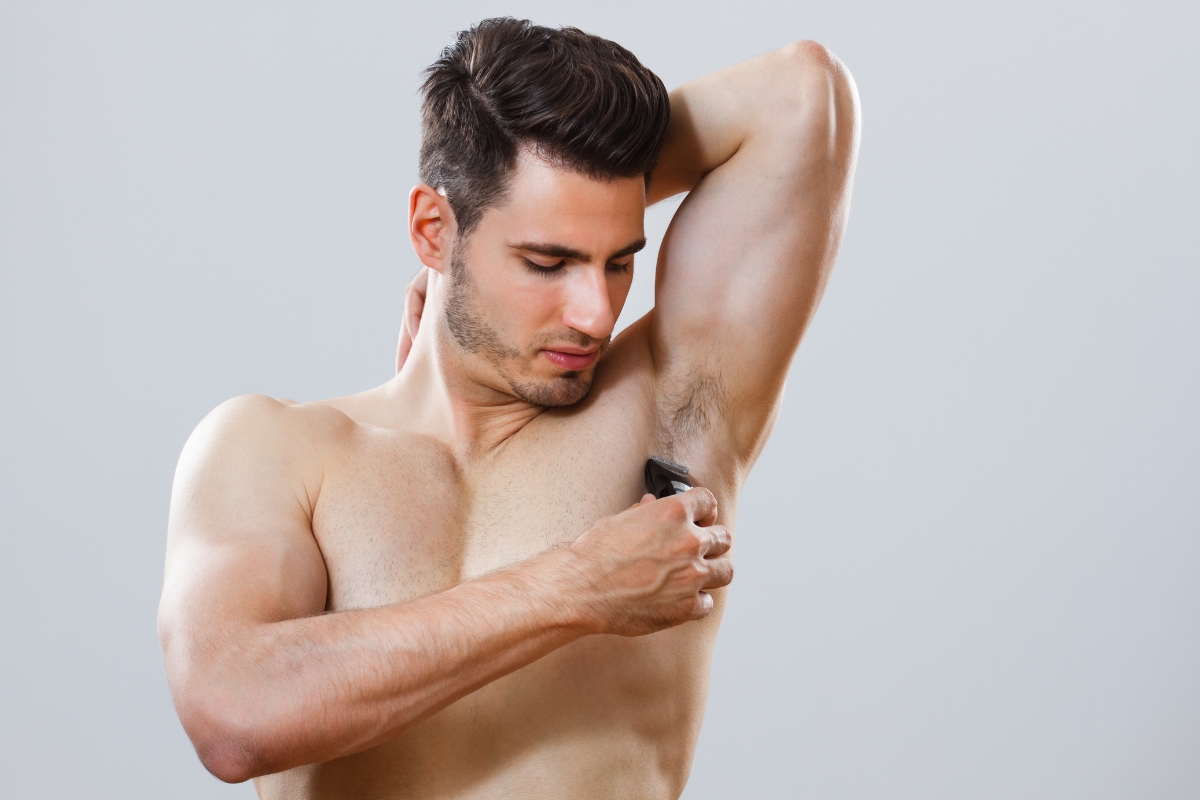 Man shaving his armpits. Photography by InesBazdar. Image via Shutterstock