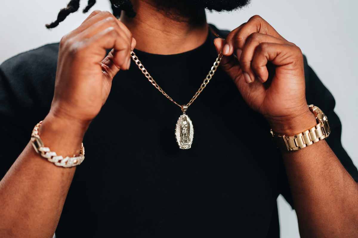 Man showing off accessories. Photography by Jacob Vega. Image via Unsplash