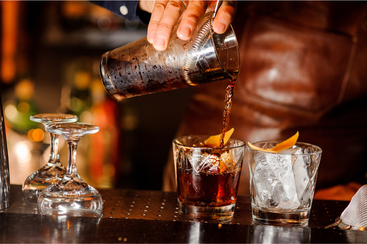 Barman pouring whiskey. Photography by Maksym Fesenko. Image via Shutterstock
