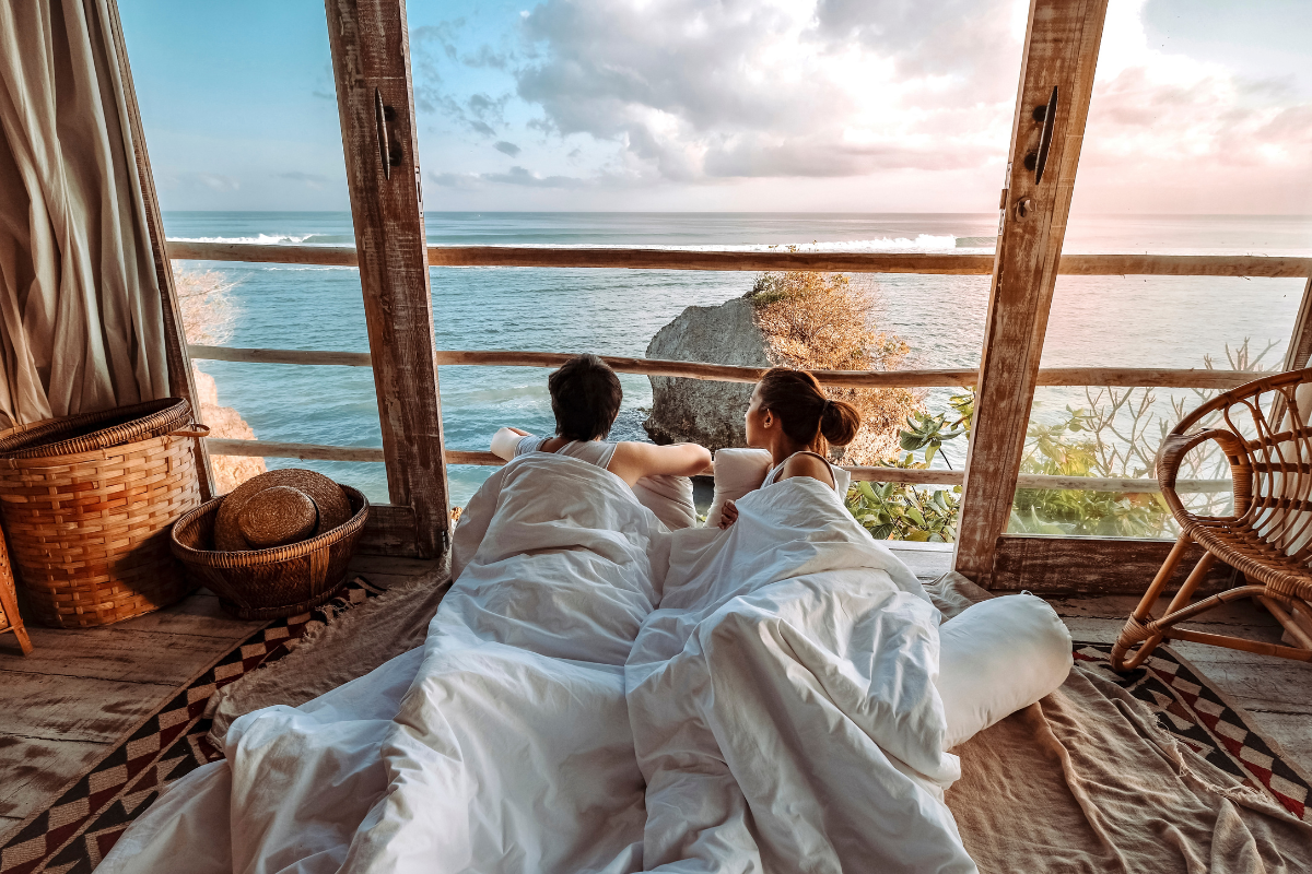 Couple in bungalow in Bali. Photography by JomNicha. Image via Shutterstock
