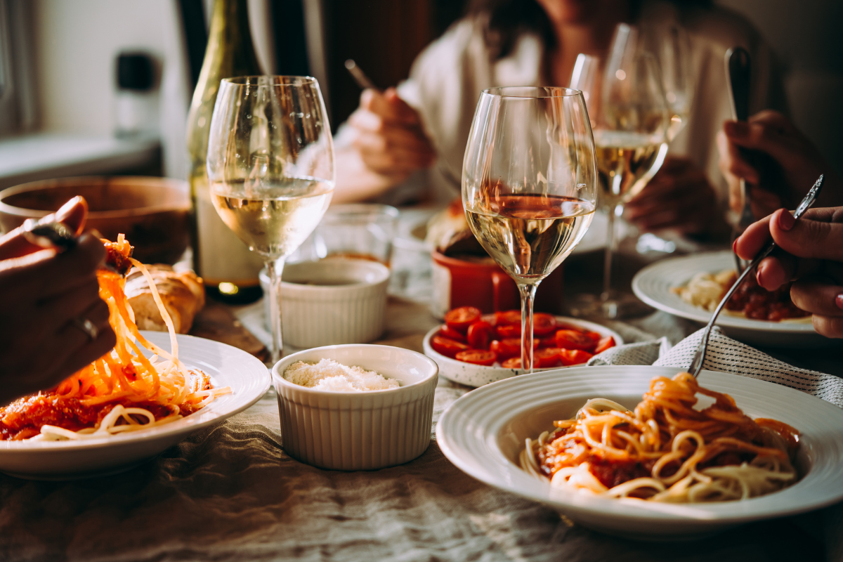 Friends at an Italian restaurant. Photography by Yulia Grigoryeva. Image via Shutterstock