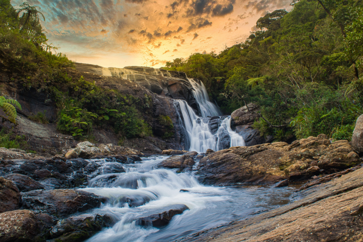 Waterfall in sunset. Photography by yazirmzm. Image via Shutterstock