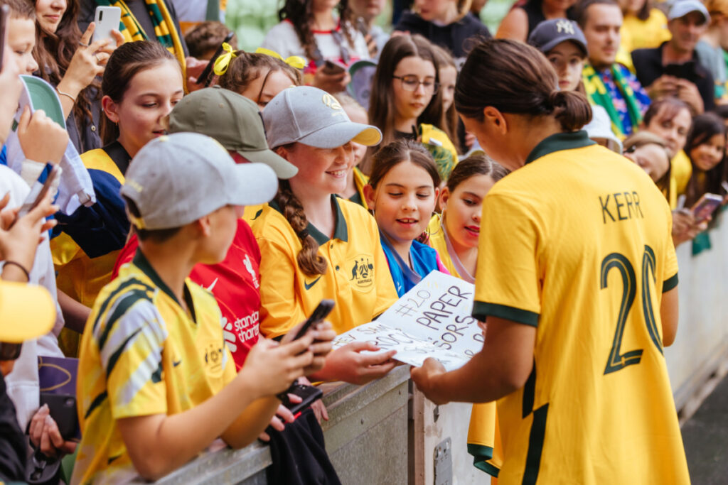 Australian woman soccer player signing for a fan. Photography by FiledIMAGE. Image via Shutterstock