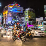 Motorbikes in Ho Chi Minh City at night. Photography by CatwalkPhotos. Image via Shutterstock