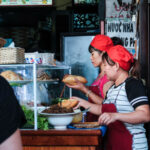 People making banh mi. Photography by Numandy. Image via Shutterstock