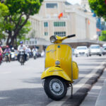 Yellow vespa on the street. Photography by Tony Duy. Image via Shutterstock