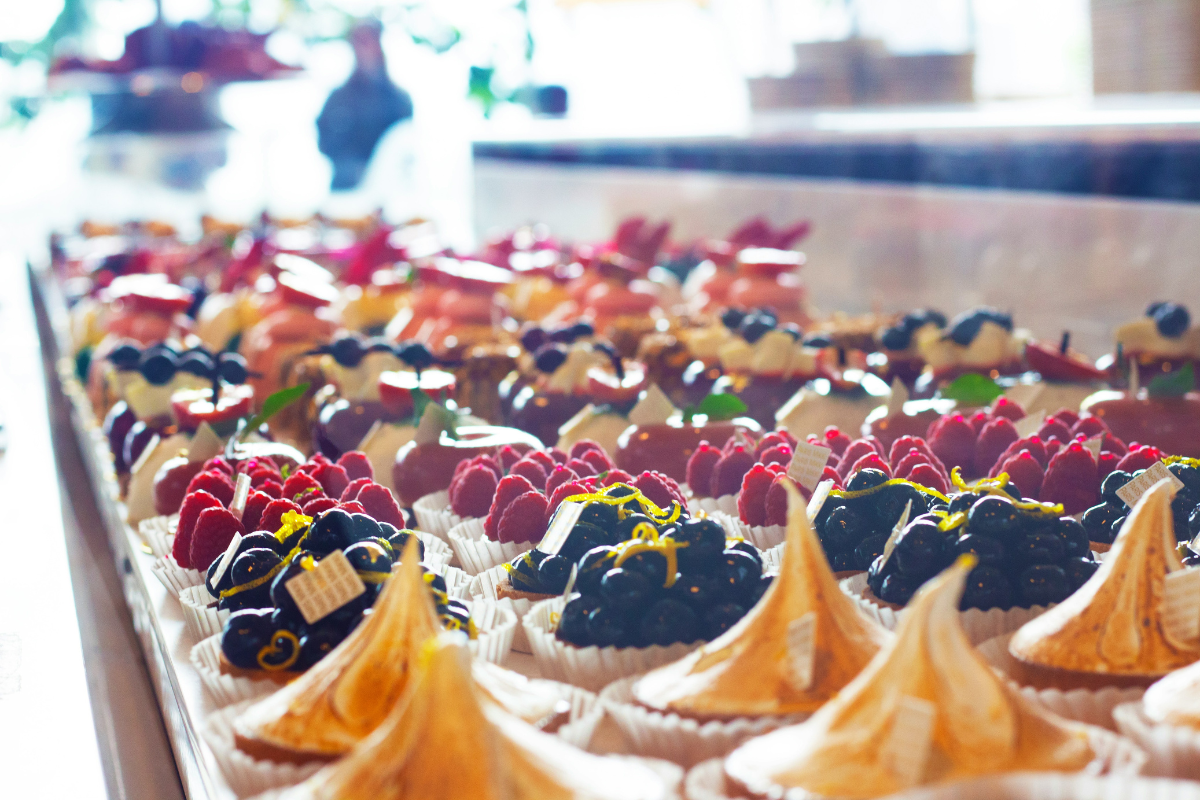 Cakes for sale in shop. Photography by Kelvin Han. Image via Unsplash