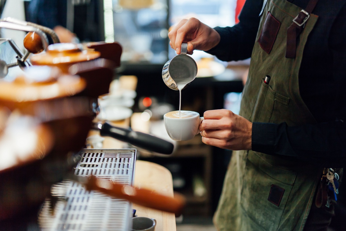Barista pouring coffee. Photography by Aleksandrs Muiznieks. Image via Shutterstock