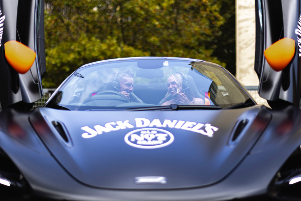 Two people sitting in a sports car. Image supplied