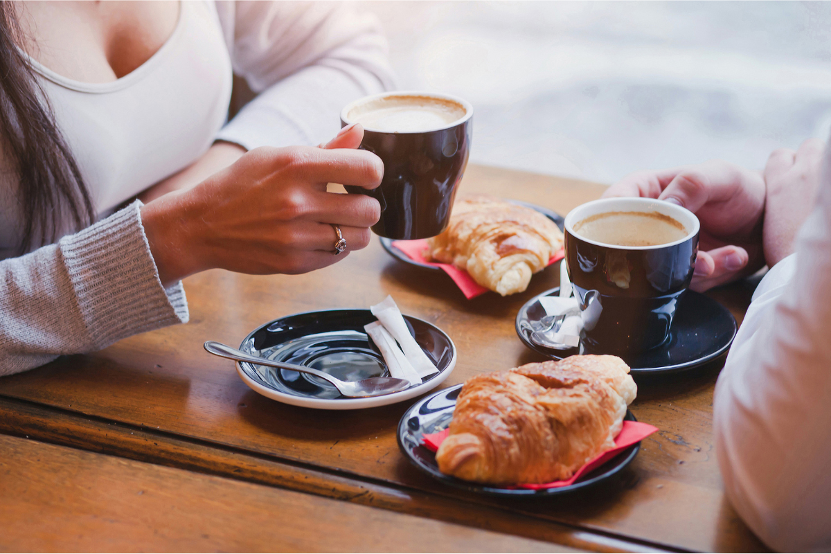 Coffee and croissants at cafe. Photography by Song_about_summer. Image via Shutterstock