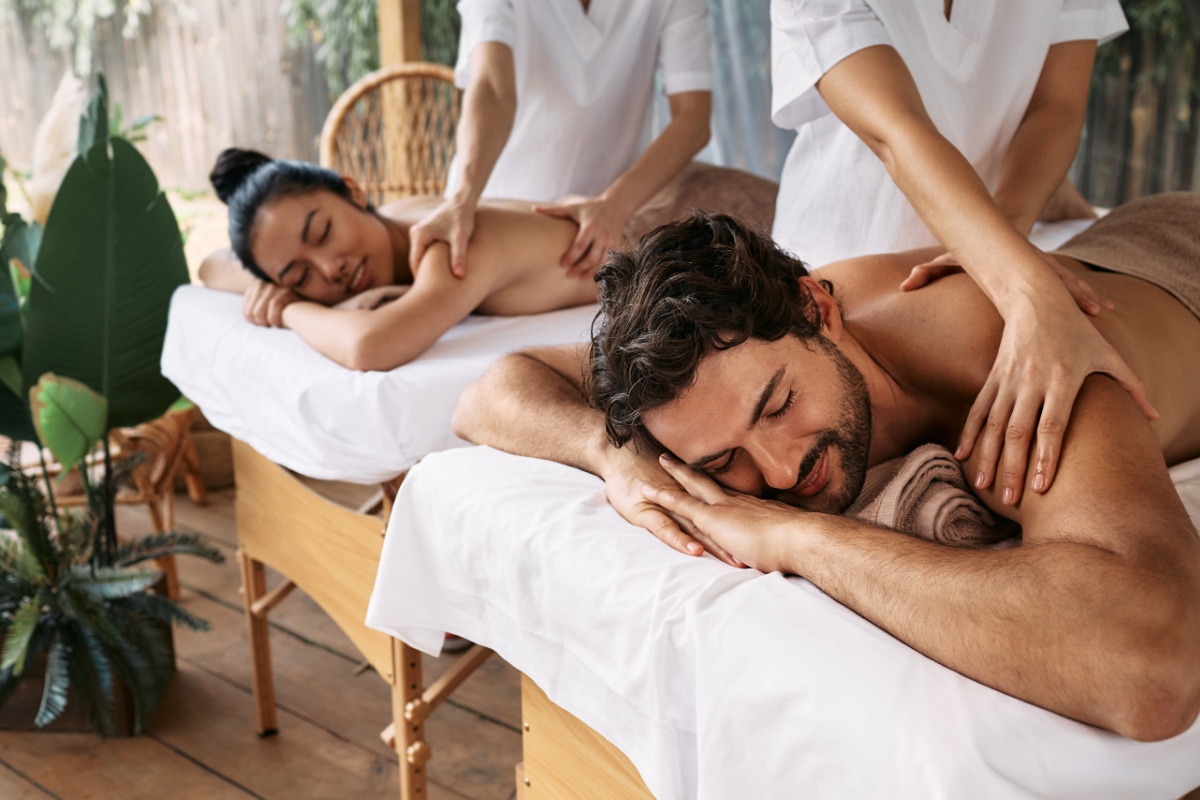 Couple taking massage. Photography by Peakstock. Image via Shutterstock
