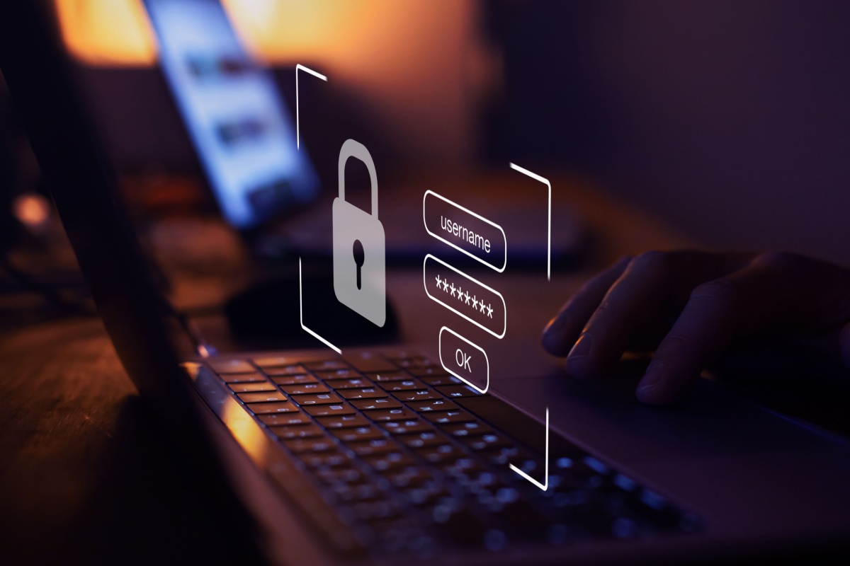 Someone logging into computer. Photography by Song_about_summer. Image via Shutterstock
