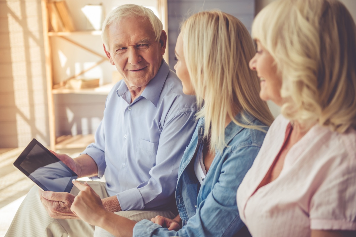 Old couple talking to young woman. Photography by VGstockstudio. Image via Shutterstock