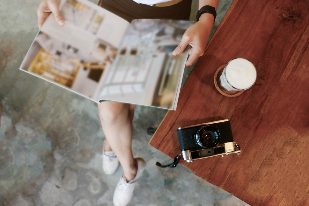 Person reading coffee table book. Photography by aporlo. Image via Shutterstock