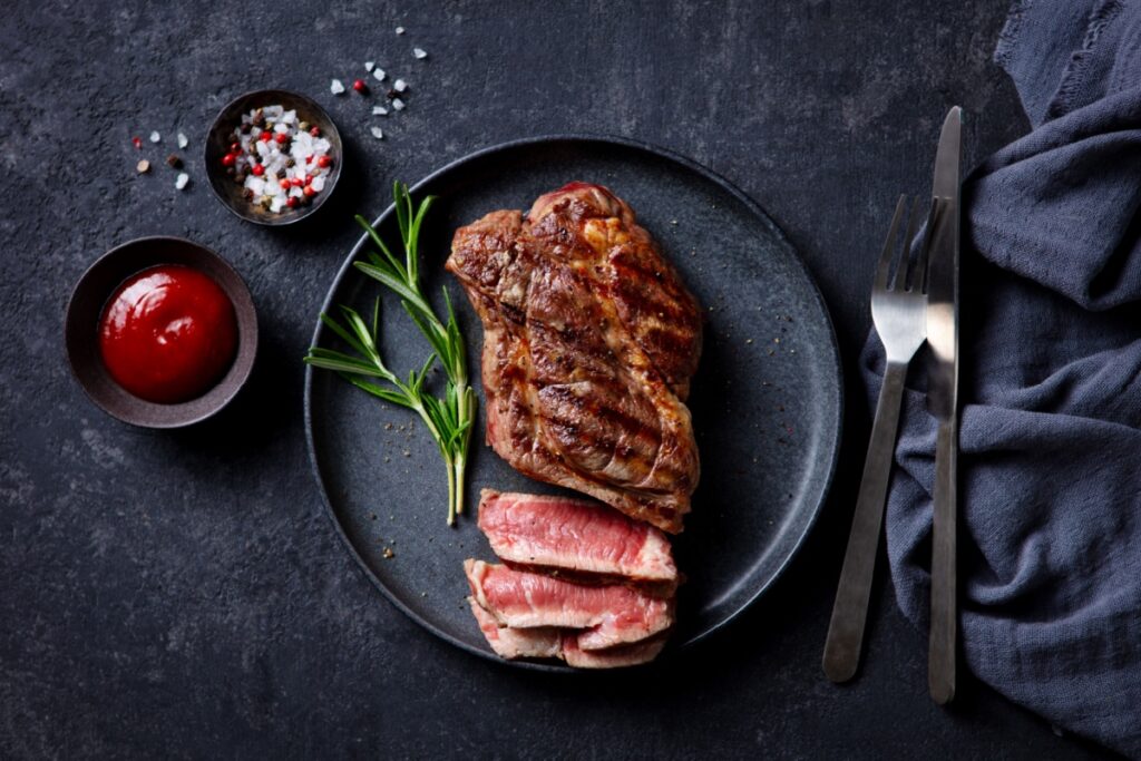 Medium Rare Steak on Black Plate. Photography by Anna_Pustynnikova via Shutterstock