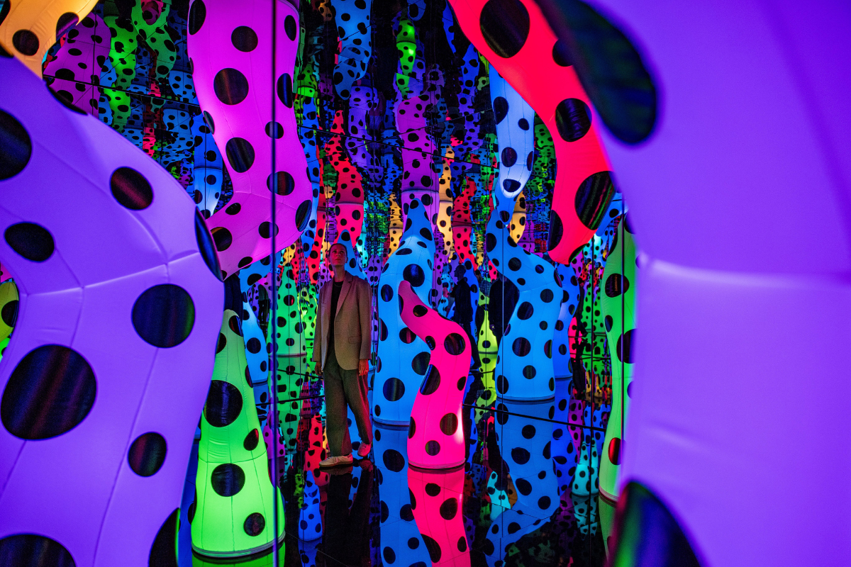 Visitors in the Yayoi Kusama exhibition at NGV International, Melbourne until 21 April 2025. © YAYOI KUSAMA. Image via Visit Victoria